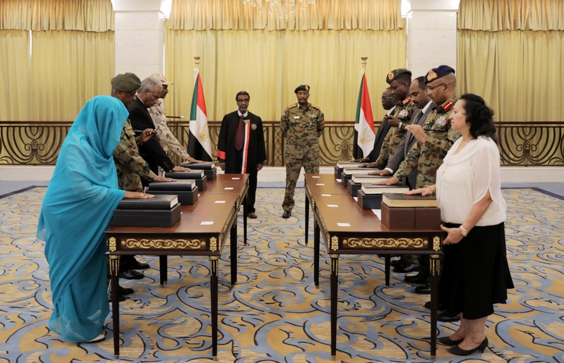 Leader of Sudan's transitional council, Lieutenant General Abdel Fattah Al-Abdelrahman Burhan looks on as military and civilian members of Sudan's new ruling body, the Sovereign Council, are sworn in at the presidential palace in Khartoum