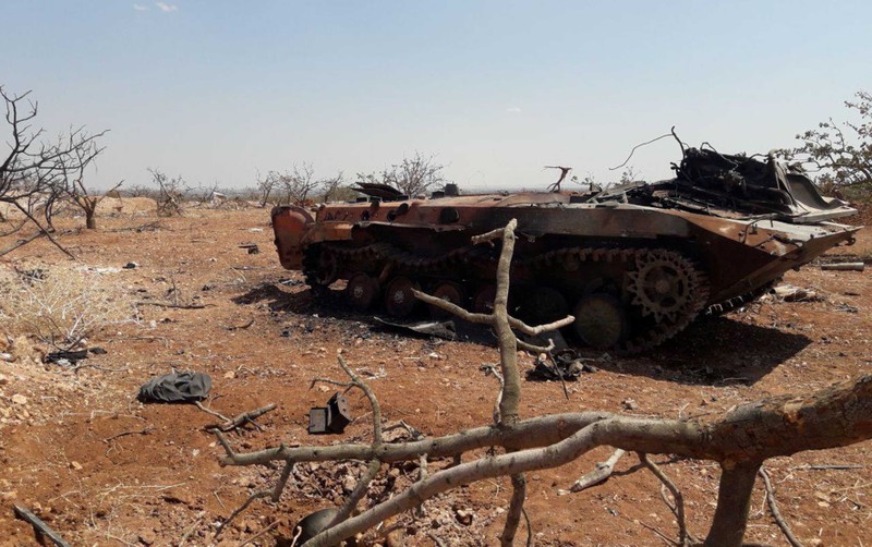 A damaged military tank is seen in Idlib countryside