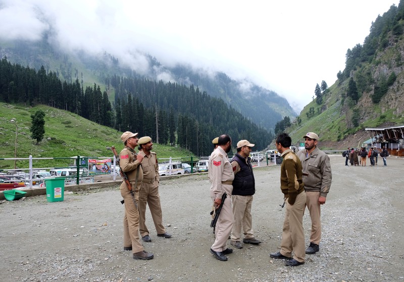 FILE PHOTO: Indian policemen stand guard at a base camp for a Hindu pilgrimage to the holy cave of Amarnath, near Pahalgam