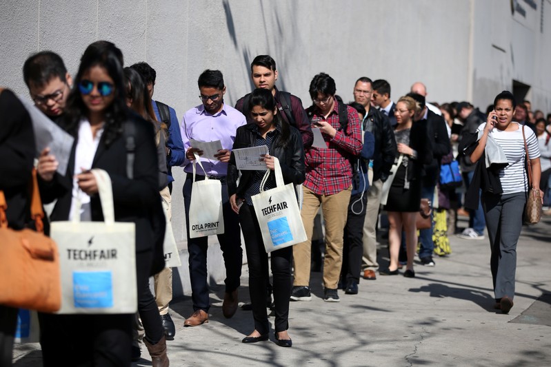 People wait in line to attend TechFair LA, a technology job fair, in Los Angeles