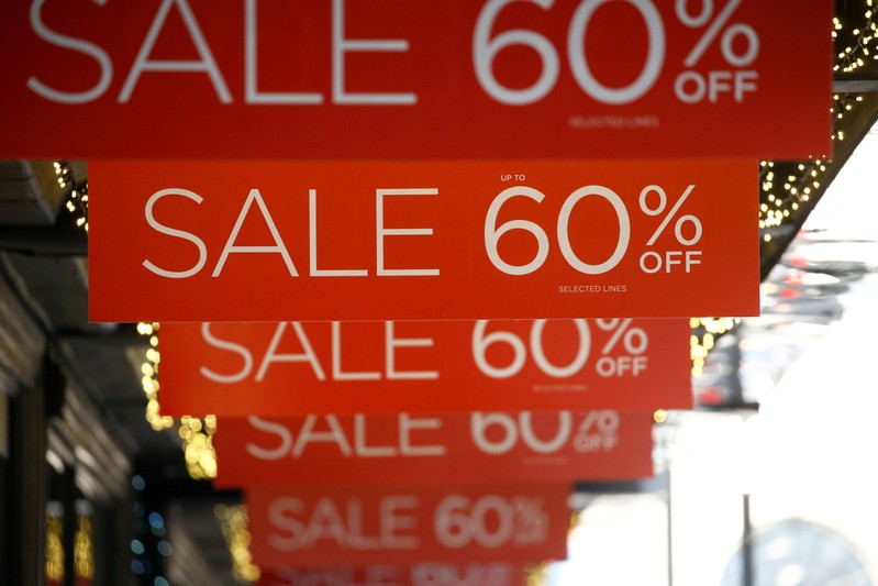 FILE PHOTO: Sale signs are displayed at the front of a shop, in London