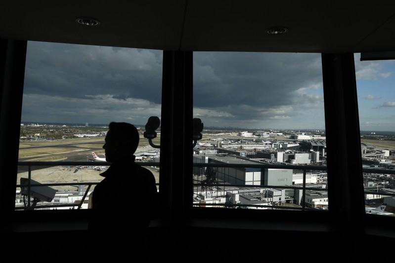 A member of staff poses at the National Air Traffic Services at Heathrow Airport near London