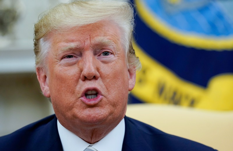 U.S. President Donald Trump answers reporters questions in the Oval office of the White House In Washington