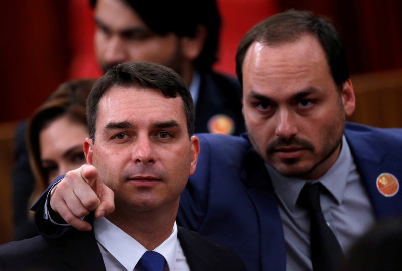 FILE PHOTO: Flavio Bolsonaro and Carlos Bolsonaro, sons of the Brazil's President-elect Jair Bolsonaro are seen before their father received a confirmation of his victory in the recent presidential election in Brasilia