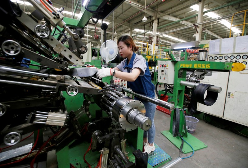 FILE PHOTO: An employee works on the production line of a tyre factory under Tianjin Wanda Tyre Group in Xingtai