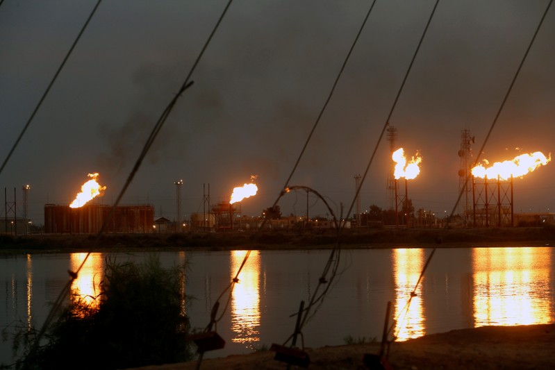 Flames emerge from flare stacks at Nahr Bin Umar oil field, north of Basra