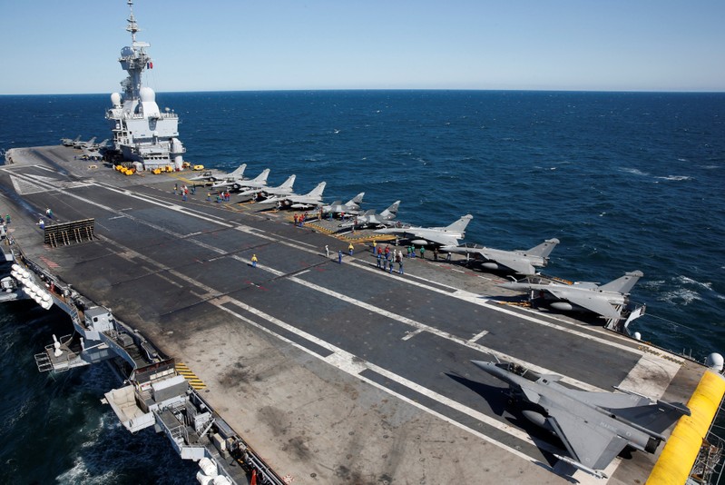 FILE PHOTO: Rafale and Super Etendards fighter jets are parked prior to a mission aboard France's Charles de Gaulle aircraft carrier sailing in the Gulf