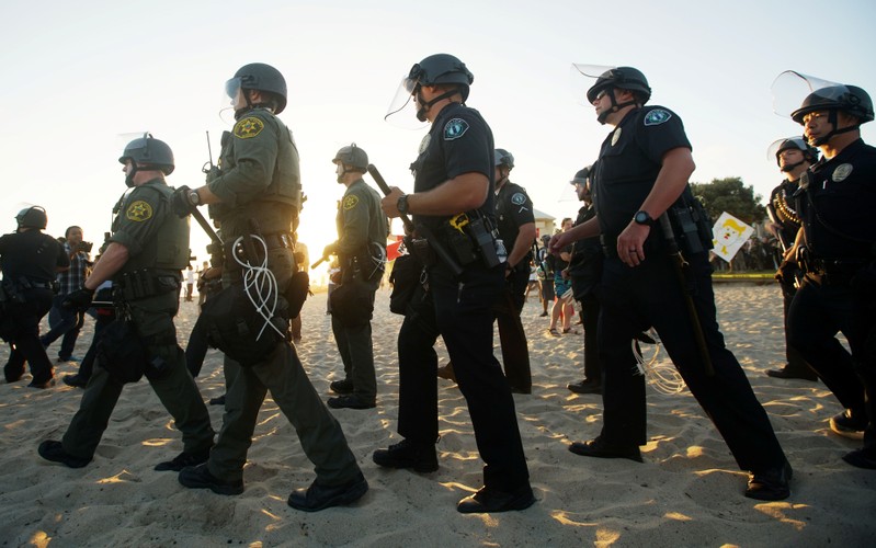 Police officers separate demonstators during an America First rally in Laguna Beach, California