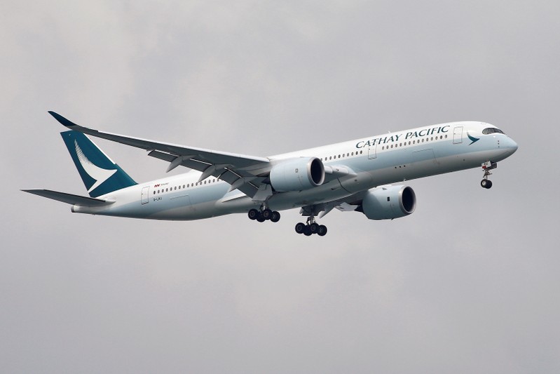 FILE PHOTO: A Cathay Pacific Airways Airbus A350 airplane approaches to land at Changi International Airport in Singapore