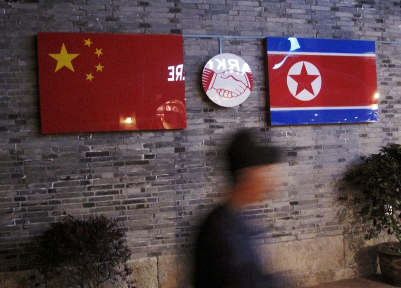 FILE PHOTO: File photo of the flags of China and North Korea seen outside the closed Ryugyong Korean Restaurant in Ningbo
