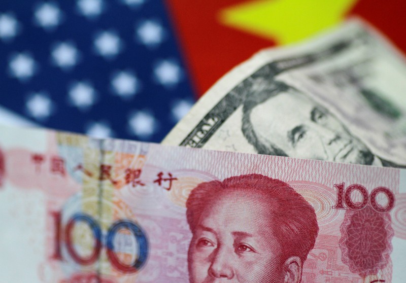 FILE PHOTO: Illustration photo of U.S. dollar and China yuan notes