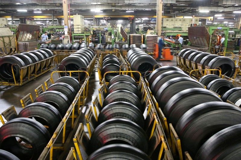 Workers are seen at a production line manufacturing tyres at a factory in Nantong, Jiangsu