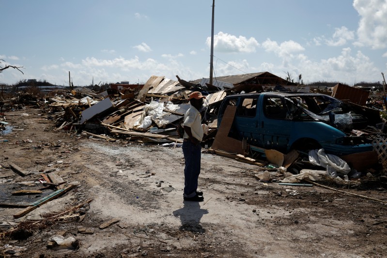 A man looks at the destroyed the Mudd neighbourhood during a search for the dead operation after Hurricane Dorian hit the Abaco Islands in Marsh Harbour