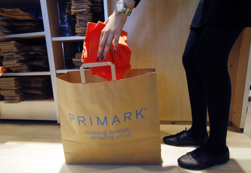 A sales assistant packs clothes at a Primark store on Oxford Street in London