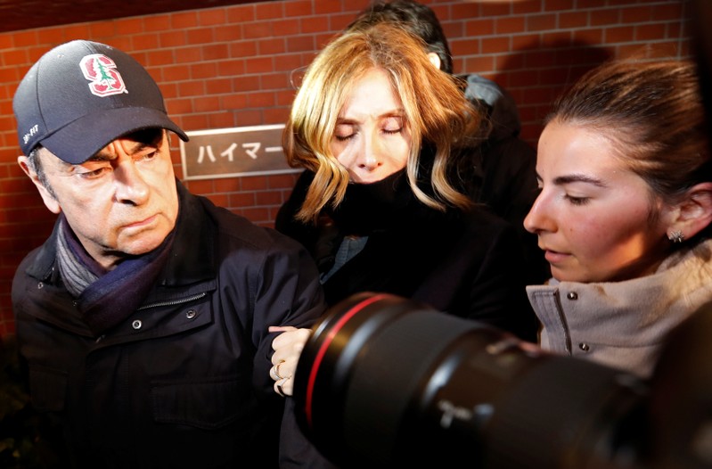 FILE PHOTO: Former Nissan Motor Chairman Carlos Ghosn accompanied by his wife Carole Ghosn, arrives at his place of residence in Tokyo