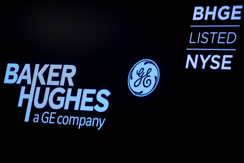 A screen displays the logo for Baker Hughes, a GE company on the floor at the NYSE in New York