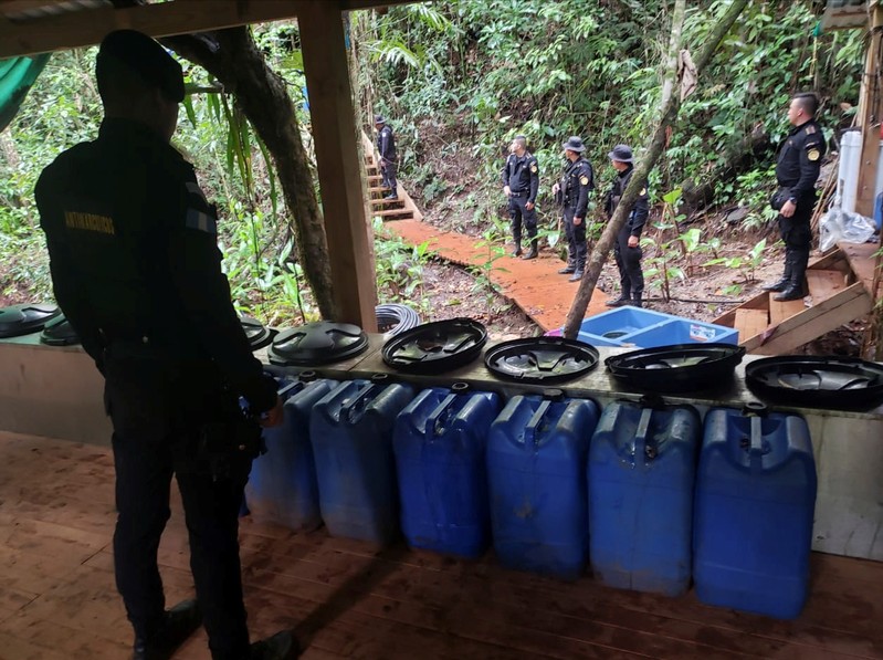 Agents of the Guatemalan National Civil Police (PNC) are seen during an operation to dismantle a coca processing lab in Izabal