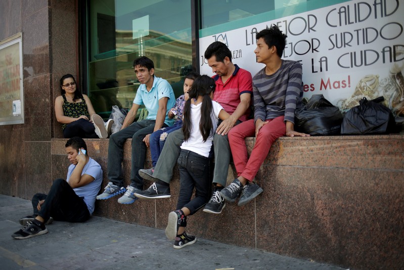FILE PHOTO: Honduran migrants rest after returning to Mexico from the U.S. under the Migrant Protection Protocol (MPP) to wait for their court hearing for asylum seekers, in Ciudad Juarez