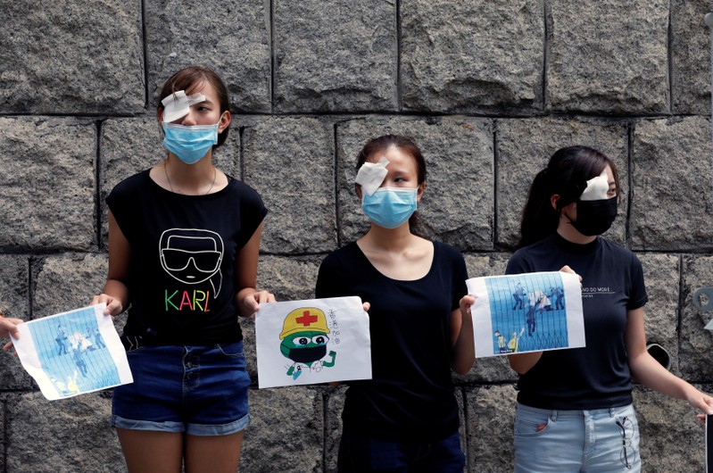 Medical students hold hands as they form a human chain during a protest against the police brutality, at the Faculty of Medicine in The University of Hong Kong