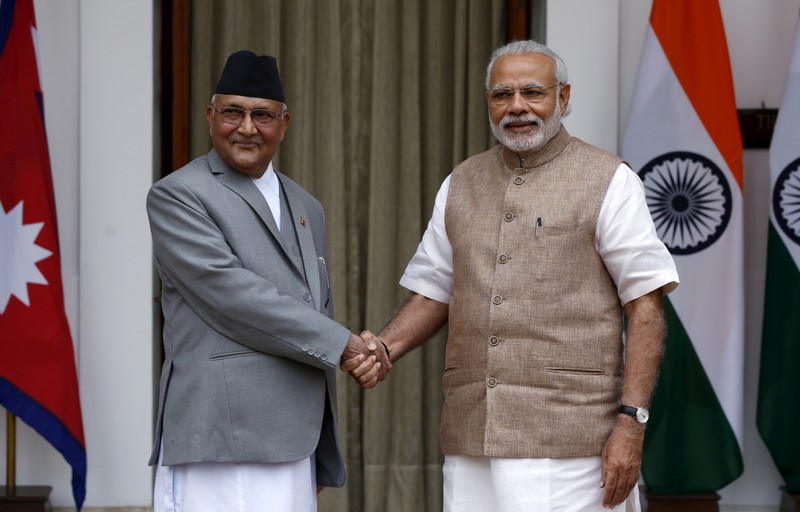 FILE PHOTO: Nepal's Prime Minister Oli shakes hands with his Indian counterpart Modi during a photo opportunity ahead of their meeting at Hyderabad House in New Delhi
