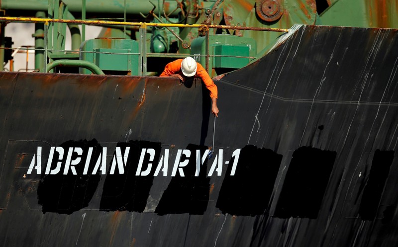 FILE PHOTO: A crew member takes pictures with a mobile phone on Iranian oil tanker Adrian Darya 1, previously named Grace 1, as it sits anchored after the Supreme Court of the British territory lifted its detention order, in the Strait of Gibraltar