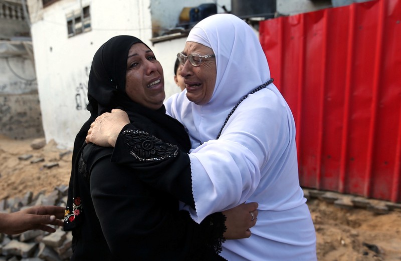 Palestinian relatives of Othman, 20, mourn during his funeral in Rafah in the southern Gaza Strip