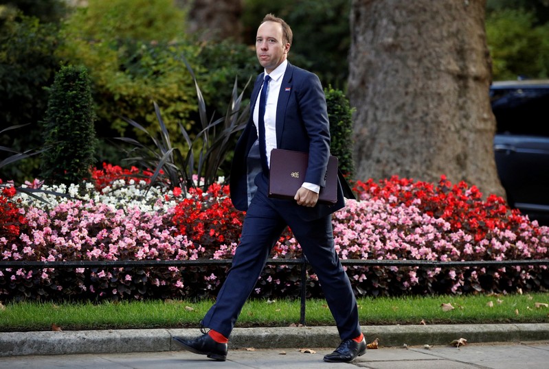 FILE PHOTO: Britain's Health Secretary Hancock walks outside 10 Downing Street in London