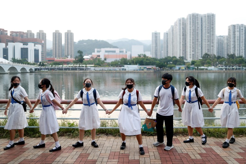 Anti-government protesters prepare a human chain in Hong Kong
