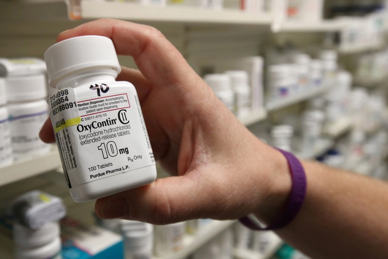 FILE PHOTO: A pharmacist holds a bottle OxyContin made by Purdue Pharma at a pharmacy in Provo, Utah