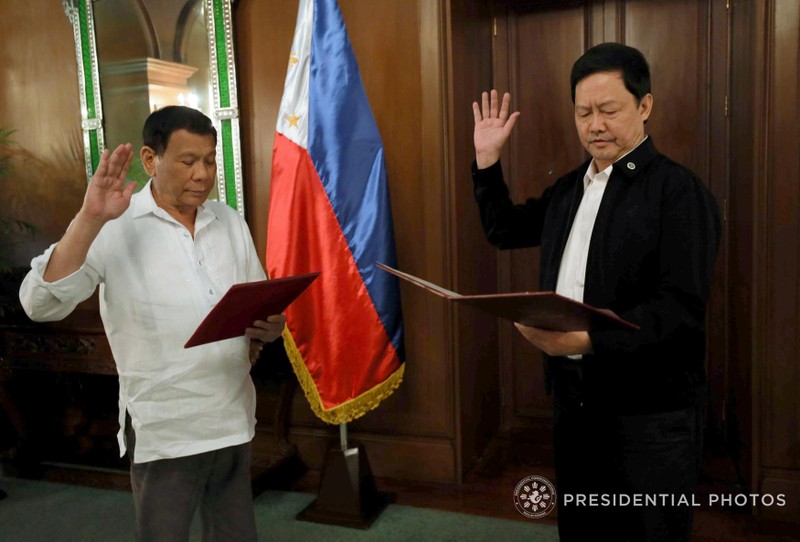 Menardo Guevarra takes an oath as justice secretary next to Philippine President Rodrigo Duterte during a ceremony at the Malacanang Presidential Palace in Metro Manila