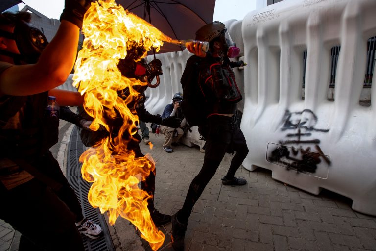 Street fires burn in Hong Kong amid running battles between protesters and police