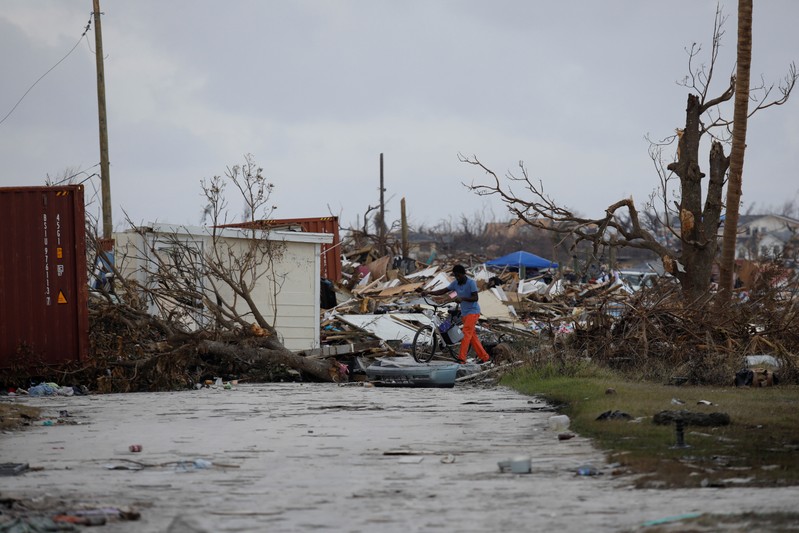 A man walks among debris at the Mudd neighborhood, devastated after Hurricane Dorian hit the Abaco Islands in Marsh Harbour