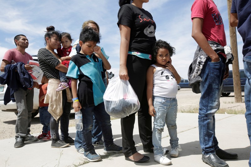 FILE PHOTO: Central American migrants stand in line before entering a temporary shelter, after illegally crossing the border between Mexico and the U.S., in Deming