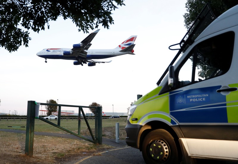 Police vehicles are seen parked near Heathrow airport after climate activists said they planned to fly drones near the airport, in London