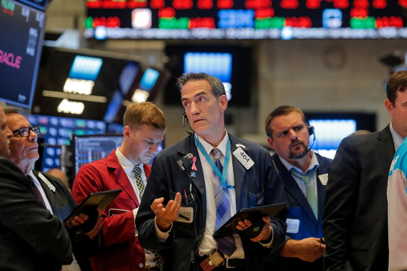 Traders work on the floor at the NYSE in New York