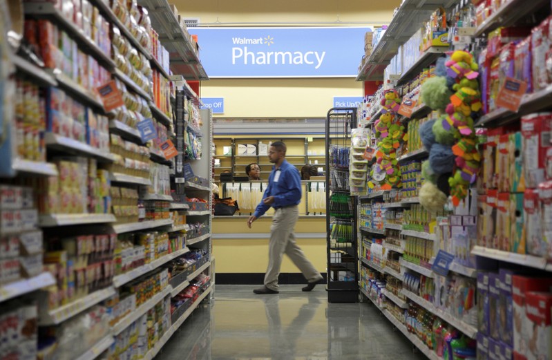 FILE PHOTO: A worker walks past the pharmacy in a new Walmart Express store in Chicago