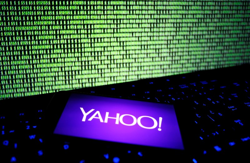 FILE PHOTO: A photo illustration shows a Yahoo logo on smartphone in front of a displayed cyber code and keyboard