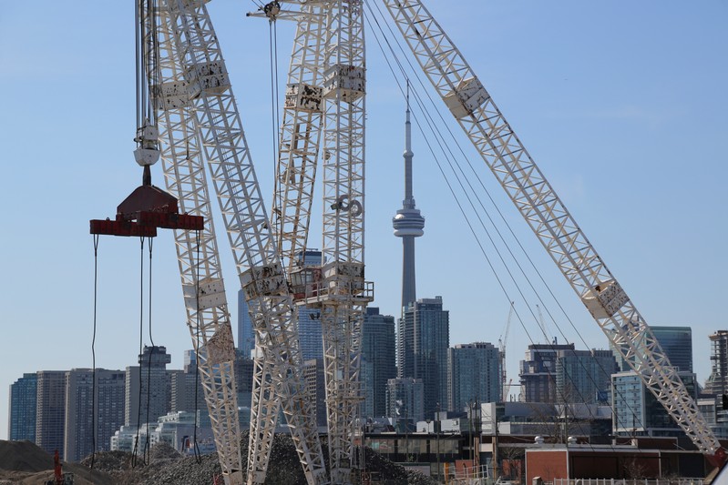 FILE PHOTO: The downtown skyline and CN Tower are seen past cranes in the waterfront area of Toronto