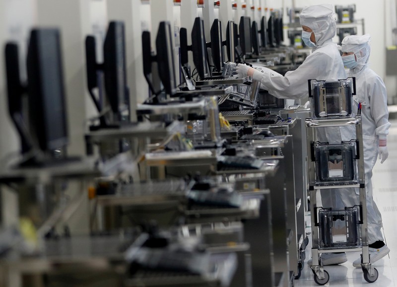 FILE PHOTO: Employees of Austrian sensor specialist AMS work in their factory in Unterpremstaetten