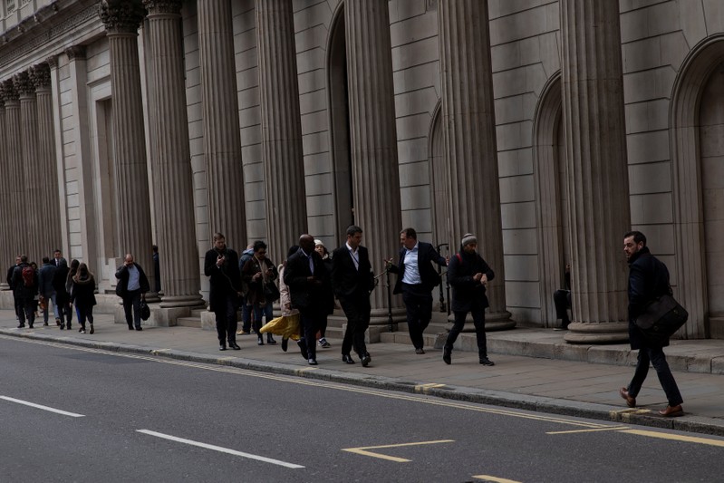 People are seen outside the Bank of England in London