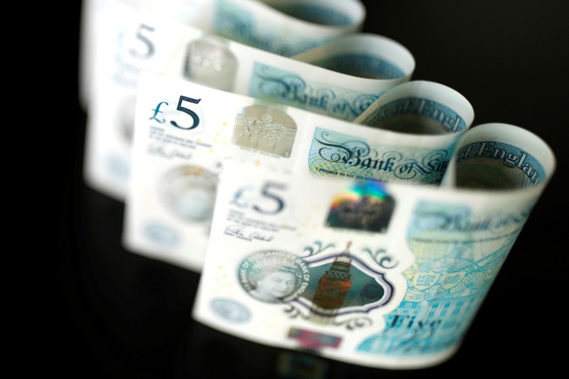 FILE PHOTO: British five pound banknotes are seen in this picture illustration