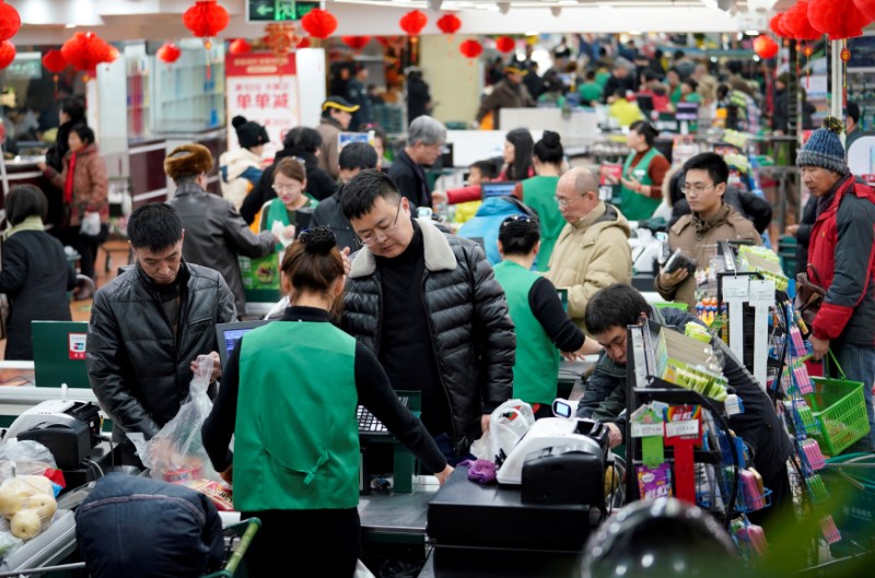 FILE PHOTO: Customers are seen in a supermarket in Beijing