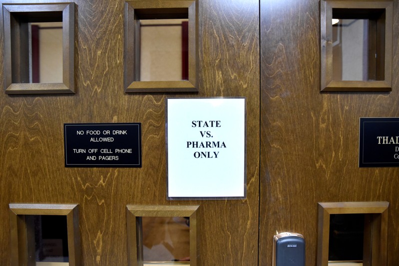 A sign is seen on the outside of the courtroom on the first day of a trial of Johnson & Johnson in Norman