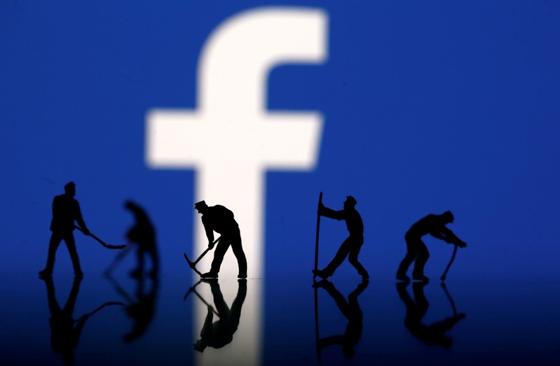 FILE PHOTO: Figurines are seen in front of the Facebook logo in this illustration