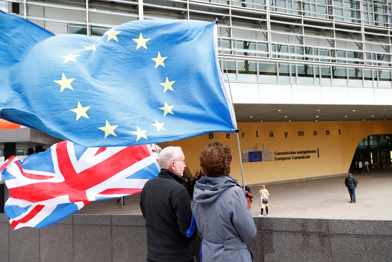 Anti-Brexit protesters hold British and European Union flags outside the EU Commission headquarters in Brussels