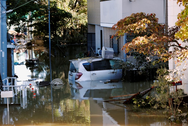 A car is seen partially submerged in a flooded residential area due to Typhoon Hagibis, near the Tama River in Kawasaki, Japan
