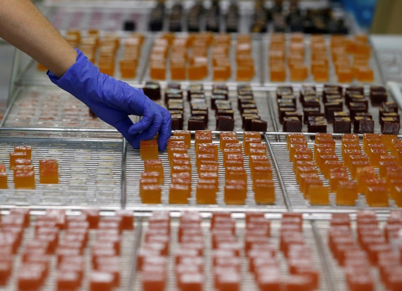 A worker prepares boxes of glace fruits and fruit jelly for export at the Cruzilles factory in Clermont-Ferrand