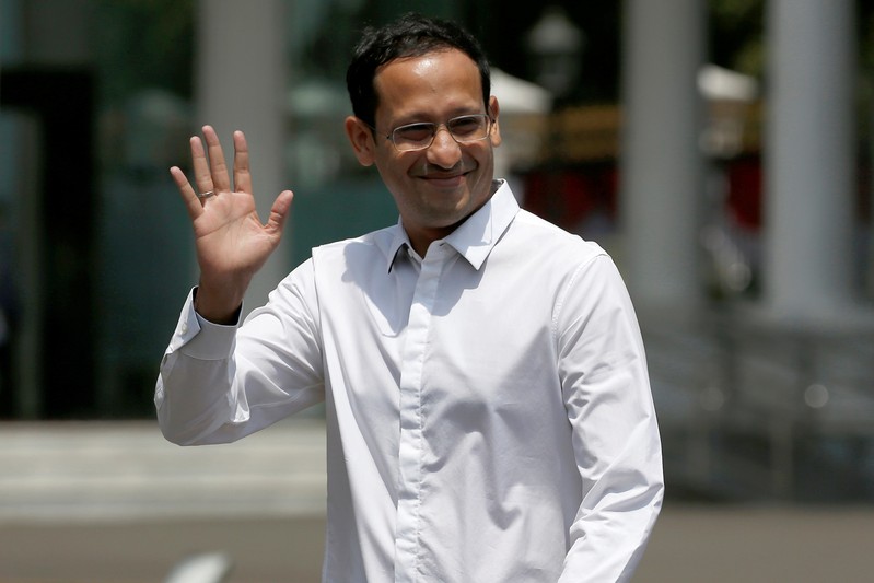 Nadiem Makarim, founder of the Indonesian ride-hailing and online payment firm Gojek waves to journalists as he arrives at the Presidential Palace in Jakarta