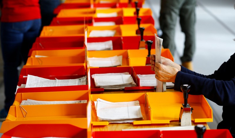 Member of the district election office Stadtkreis 3 sorts ballots for the Swiss federal elections in Zurich