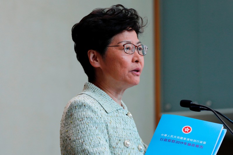 Hong Kong Chief Executive Carrie Lam holds copies of her annual policy address to journalists before a weekly Executive Council meeting in Hong Kong